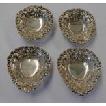 SET OF 4 SILVER HEART SHAPED DISHES WITH PIERCED WORK DECORATION ON BALL FEET,