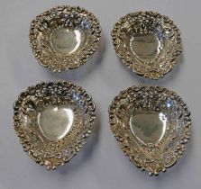 SET OF 4 SILVER HEART SHAPED DISHES WITH PIERCED WORK DECORATION ON BALL FEET,