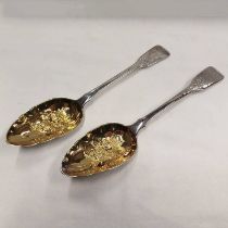 PAIR OF GEORGE III SILVER BERRY TABLESPOONS WITH GILDED FOLIATE EMBOSSED BOWLS,
