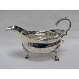 GEORGE III SILVER SAUCE BOAT WITH SCROLL HANDLE ON PAD FEET,