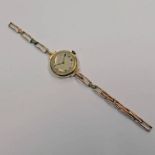 15CT GOLD LADIES WRISTWATCH ON A GOLD PLATED EXPANDING BRACELET