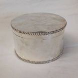 SILVER CIRCULAR BISCUIT BOX WITH HINGED LID BY GOLDSMITHS & SILVERSMITHS CO.