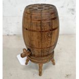 CARVED WOODEN POP UP CIGARETTE DISPENSER IN THE FORM OF A WHISKY BARREL ON A STAND,