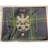 ABERDEENSHIRE ARTILLERY VOLUNTEERS HELMET PLATE MOUNTED ON TARTAN FABRIC ALONG WITH 2 KILT PINS,