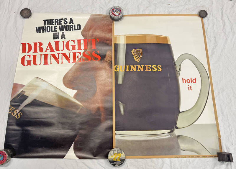 2 UNFRAMED GUINESS POSTERS "THERES A WHOLE WORLD IN A DRAUGHT GUINESS" AND "HOLD IT" 51 X 74CM