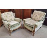 PAIR OF 19TH CENTURY CARVED WALNUT FRAMED OVERSTUFFED ARMCHAIRS ON DECORATIVE PAW FEET