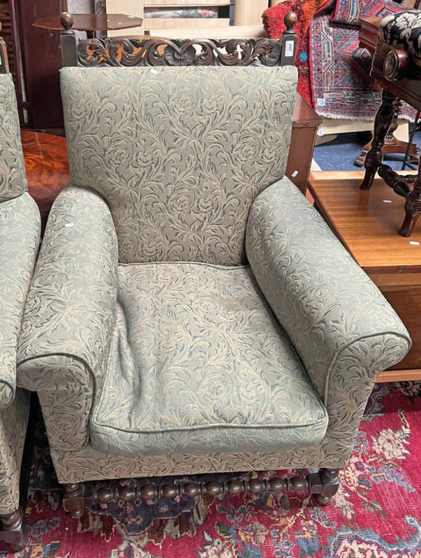 LATE 19TH CENTURY OAK FRAMED OVERSTUFFED ARMCHAIR WITH CARVED DECORATION TO BACK ON BOBBIN SUPPORTS