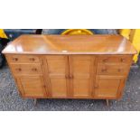 ERCOL ELM SIDEBOARD WITH 2 CENTRALLY SET PANEL DOORS FLANKED TO EACH SIDE BY 2 DRAWERS OVER 2 PANEL