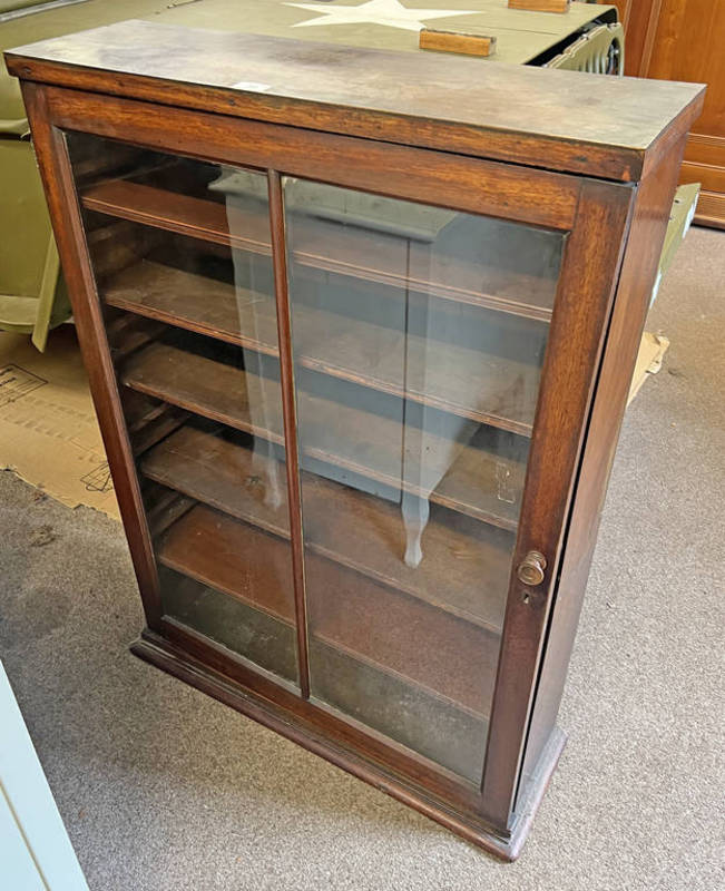 MAHOGANY BOOKCASE WITH SINGLE GLAZED PANEL DOOR OPENING TO SHELVED INTERIOR,