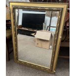 DECORATIVE GILT FRAMED RECTANGULAR MIRROR WITH BEVELLED EDGE.