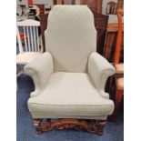 20TH CENTURY OAK FAMED OVERSTUFFED ARMCHAIR ON BALUSTER SUPPORTS WITH DECORATIVE CARVED