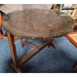 EASTERN HARDWOOD FLIP TOP CIRCULAR TABLE WITH CARVED ORIENTAL SCENE DECORATION TO TOP