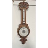 EARLY 20TH CENTURY CARVED OAK CASED ANEROID BAROMETER