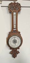 EARLY 20TH CENTURY CARVED OAK CASED ANEROID BAROMETER