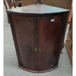 19TH CENTURY MAHOGANY BOW FRONT CORNER CABINET WITH 2 PANEL DOORS OPENING TO SHELVED INTERIOR