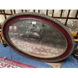 LATE 19TH CENTURY ROSEWOOD FRAMED OVAL MIRROR WITH GILT DECORATION