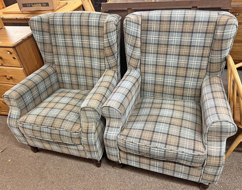 PAIR OF OVERSTUFFED WINGBACK ARMCHAIRS WITH PLAID UPHOLSTERY ON TURNED SUPPORTS.