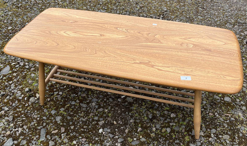 ERCOL BLONDE BEECH COFFEE TABLE ON TAPERED SUPPORT.