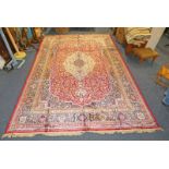 RICH RED GROUND FULL PILE CASHMERE CARPET WITH TRADITIONAL FLORAL MEDALLION DESIGN - 330 X 232 CM