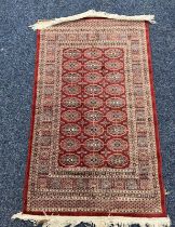 RED GROUND MIDDLE EASTERN RUG 120 X 70 CM