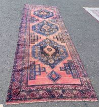 IRANIAN RUNNER WITH WASHED RED GROUND TRIPLE MEDALLION DESIGN,