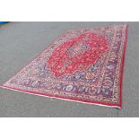 RICH RED GROUND IRANIAN CARPET WITH TRADITIONAL FLORAL MEDALLION DESIGN 287 X 400CM