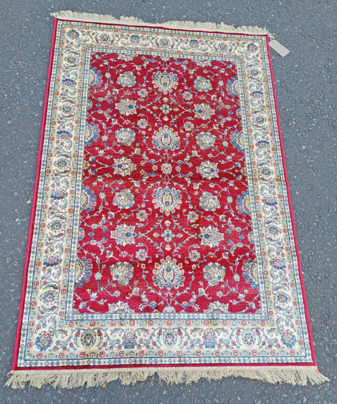 RED GROUND FULL PILE KASHMIR RUG ALL OVER FLORAL DESIGN.