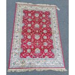 RED GROUND FULL PILE KASHMIR RUG ALL OVER FLORAL DESIGN.