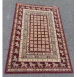 BURGUNDY GROUND FULL WOOL PILE RUG WITH UNIQUE DESIGN WITH ANIMAL MOTIVES 196 X 130CM