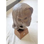 PLASTER BUST OF A YOUNG WOMAN ON A WOODEN STAND,