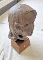 PLASTER BUST OF A YOUNG WOMAN ON A WOODEN STAND,