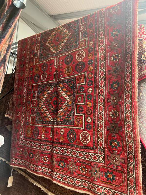 LARGE RED GROUND MIDDLE EASTERN CARPET WITH ALL OVER DESIGN AND BORDERS,