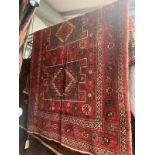 LARGE RED GROUND MIDDLE EASTERN CARPET WITH ALL OVER DESIGN AND BORDERS,