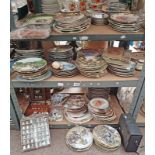 LARGE SELECTION OF WALL PLATES, 2 STAMP ALBUMS, LARGE SELECTION OF PORCELAIN THIMBLES IN RACKS,