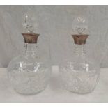 PAIR OF SILVER MOUNTED CUT GLASS DECANTERS