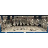 LARGE SELECTION OF WINE GLASSES ON ONE SHELF