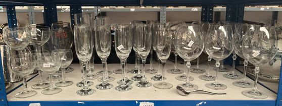 LARGE SELECTION OF WINE GLASSES ON ONE SHELF