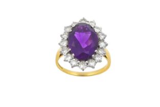 An 18 Carat Gold Amethyst and Diamond Cluster Ring the oval cut amethyst within a border of round