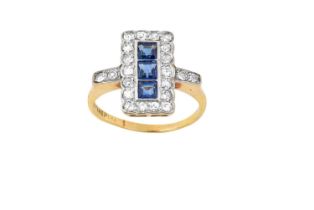 A Sapphire and Diamond Cluster Ring three square step cut sapphires within a border of old cut