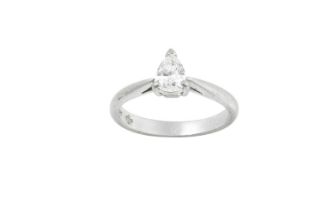 A Platinum Diamond Solitaire Ring the pear cut diamond in a claw setting, to a tapered shoulder