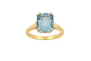 A 9 Carat Gold Aquamarine Ring the emerald-cut aquamarine in a rose claw setting, to a tapered