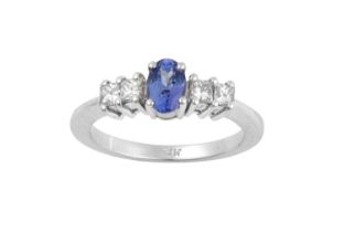 A Tanzanite and Diamond Five Stone Ring the oval cut tanzanite flanked by pairs of princess cut