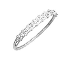 A Diamond Bangle three rows of round brilliant cut diamonds in white rubbed over settings,