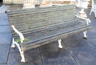 A Victorian Cast Iron and Later Painted Garden Bench, late 19th century, of curved form, the end