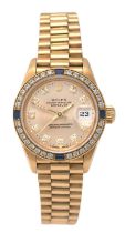 Rolex: A Lady's 18 Carat Gold Diamond and Sapphire Set Automatic Calendar Centre Seconds Wristwatch,