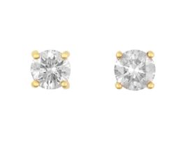 A Pair of Diamond Solitaire Earrings the round brilliant cut diamonds in yellow four claw