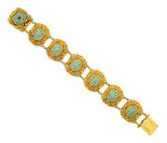 A Turquoise Bracelet comprising of seven chain linked oval panels within cartouche borders, set