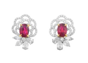 A Pair of Ruby and Diamond Cluster Earrings the oval cut rubies in yellow claw settings, with an