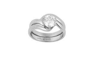 A Platinum Diamond Solitaire Ring and A Platinum Bespoke Band Ring the round brilliant cut diamond