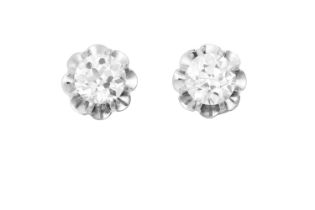 A Pair of Diamond Solitaire Earrings the old cut diamonds in white claw settings, to a scalloped